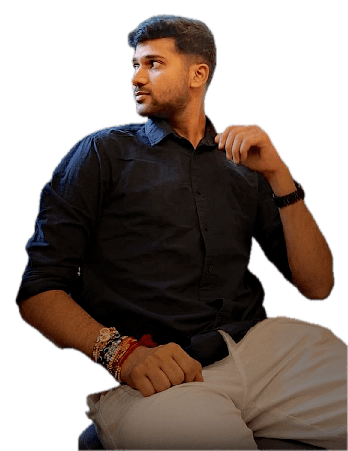 Abhinav Verma in a black shirt, lit softly from the front and emerging from the dark